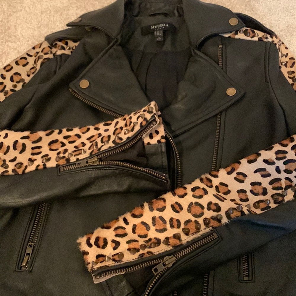 NWOT leather jacket with studded trim on sleeves.